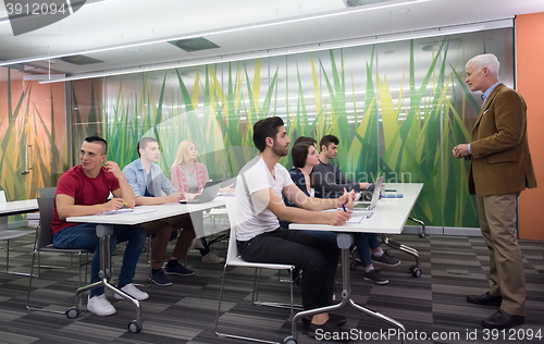 Image of teacher with a group of students in classroom