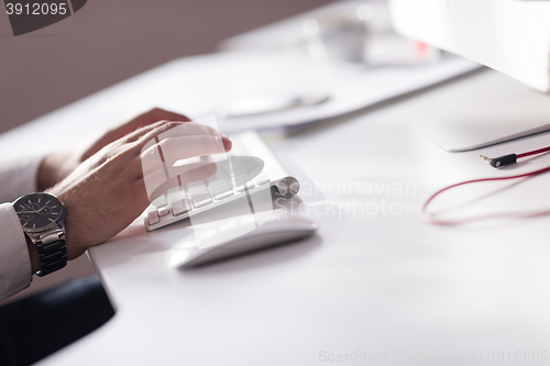 Image of hands typing on desktop computer