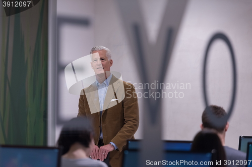 Image of teacher and students in computer lab classroom