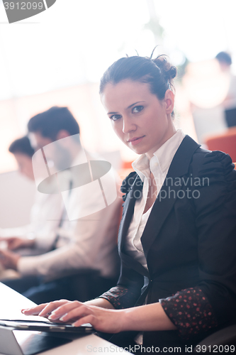 Image of business woman on meeting  using tablet