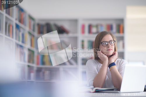 Image of female student study in school library
