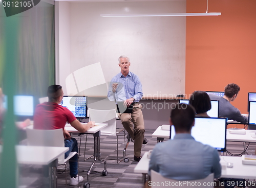 Image of teacher and students in computer lab classroom