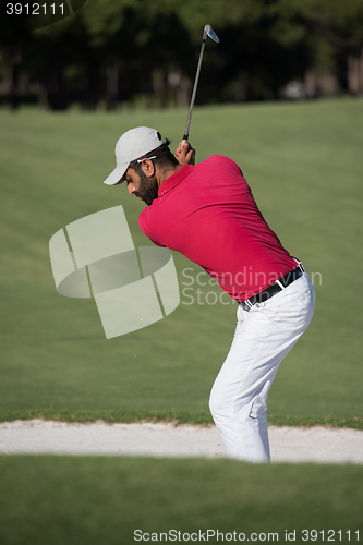 Image of golfer hitting a sand bunker shot