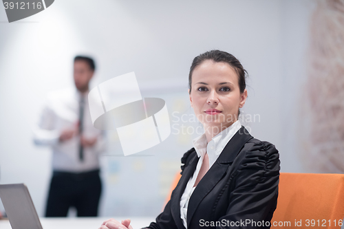 Image of young business woman on meeting  using laptop computer