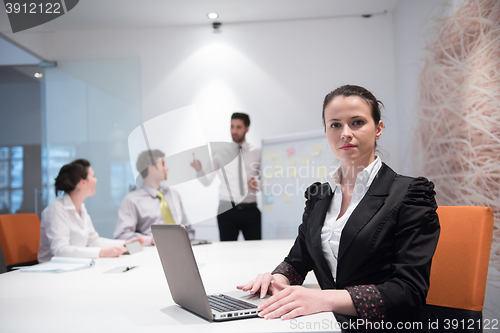 Image of young business woman on meeting  using laptop computer