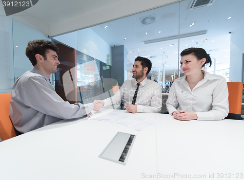 Image of young couple signing contract documents on partners back