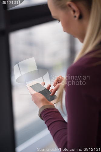 Image of business woman using smart phone at office