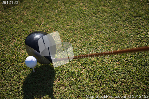 Image of golf club and ball in grass