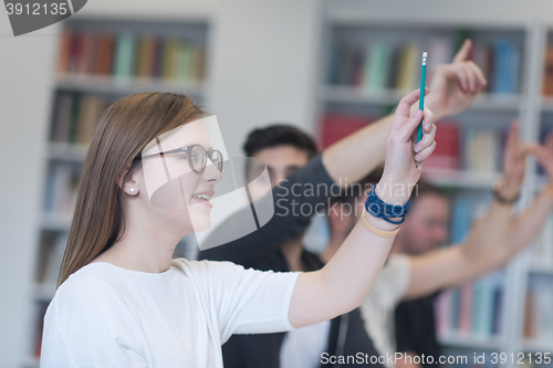 Image of group of students  raise hands up