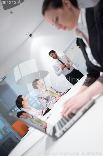 Image of young business woman on meeting  using laptop computer