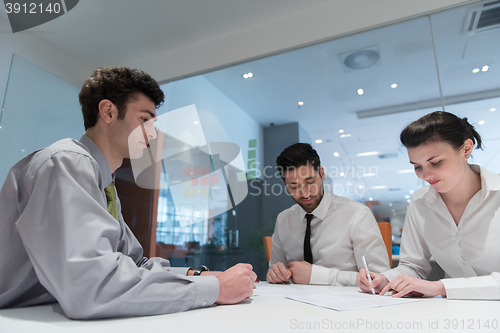 Image of young couple signing contract documents on partners back