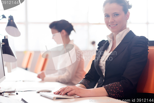 Image of business woman at  office people group in background