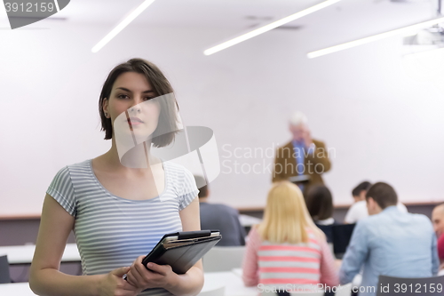 Image of portrait of happy female student in classroom