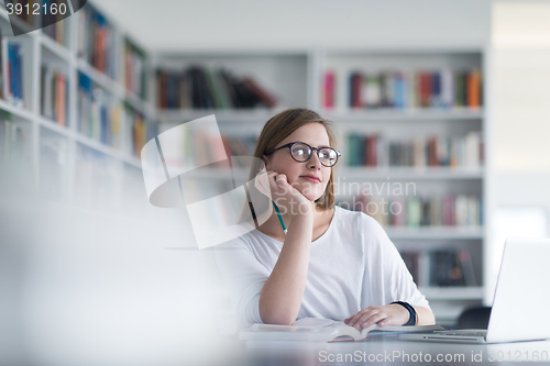 Image of female student study in school library