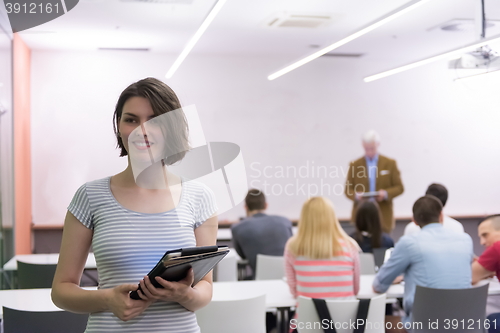 Image of portrait of happy female student in classroom