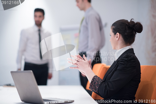 Image of young business woman on meeting  using laptop computer