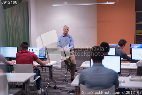 Image of teacher and students in computer lab classroom