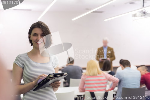 Image of portrait of happy female student in classroom