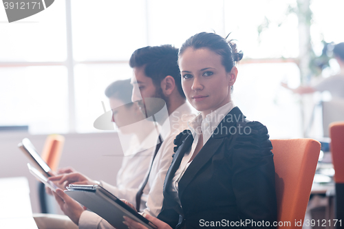 Image of business woman on meeting  using tablet