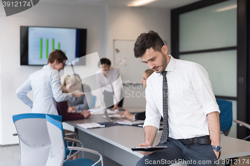 Image of young business man with tablet at office meeting room