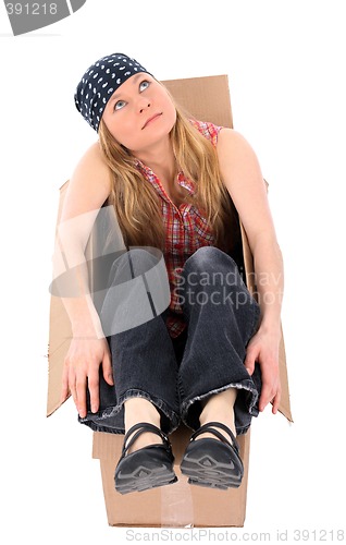 Image of Girl sitting in a cardboard box, looking up