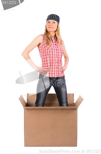 Image of Proud woman standing in a cardboard box