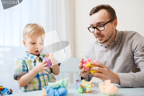 Image of father and son playing with ball clay at home