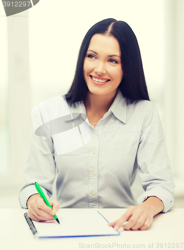 Image of smiling businesswoman or student studying