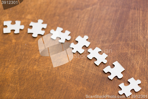 Image of close up of puzzle pieces on wooden surface