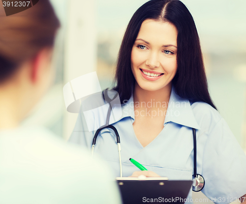 Image of smiling doctor or nurse with patient