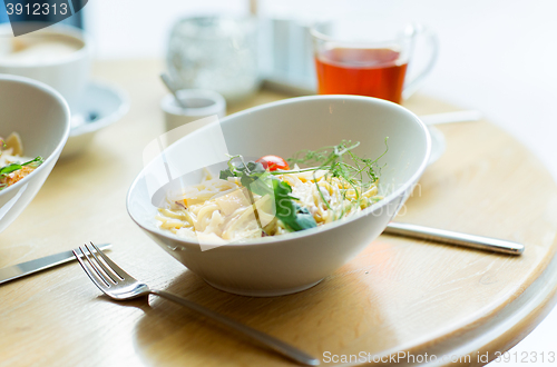 Image of close up of pasta in bowl on table at restaurant