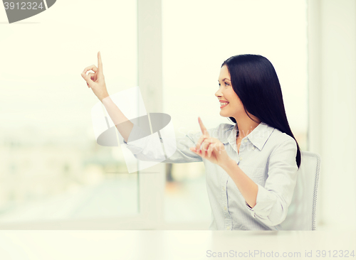 Image of smiling woman pointing to something imaginary