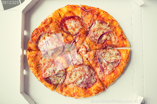 Image of close up of pizza in paper box on table