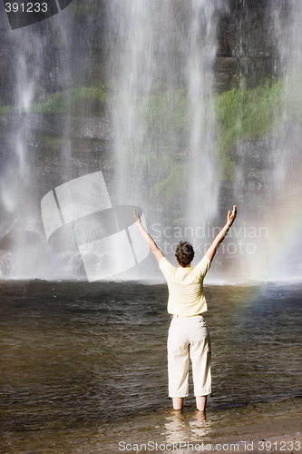 Image of Woman and tropical waterfall