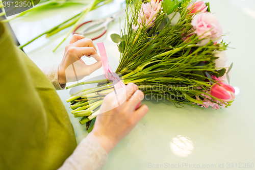 Image of close up of woman making bunch at flower shop
