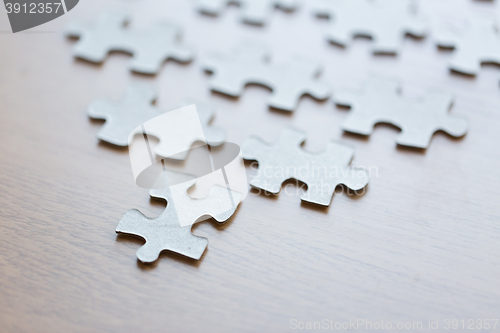 Image of close up of puzzle pieces on wooden surface