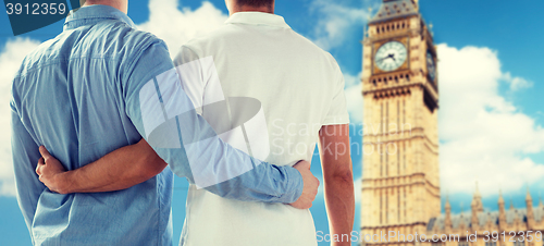 Image of close up of male gay couple hugging over big ben