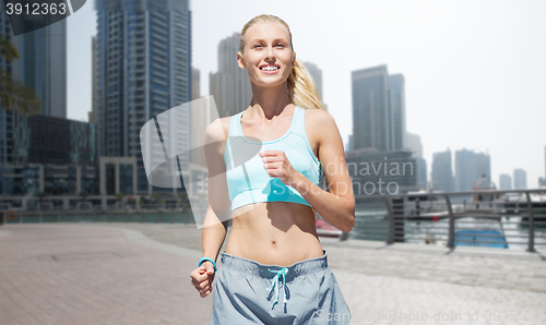 Image of woman running or jogging over dubai city street