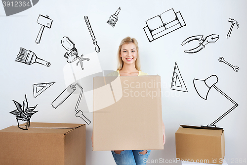 Image of smiling young woman with cardboard box at home