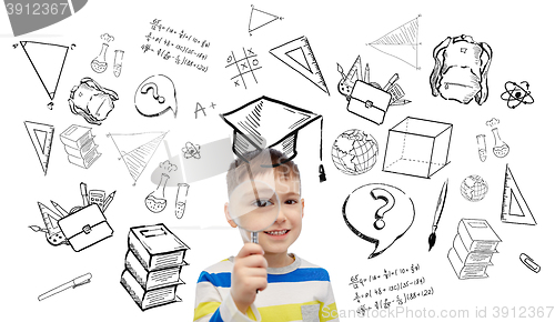 Image of happy little boy looking through magnifying glass