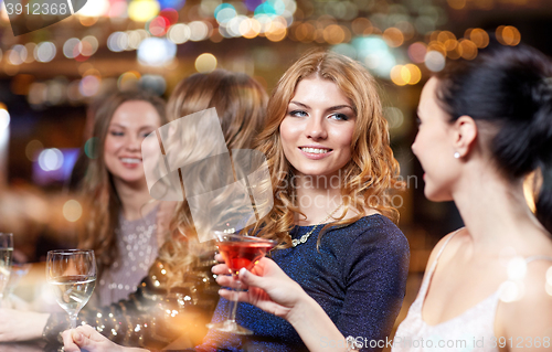 Image of happy women with drinks at night club