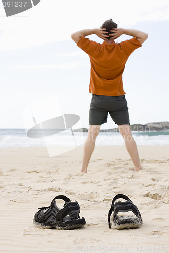 Image of Man doing exercises on beach
