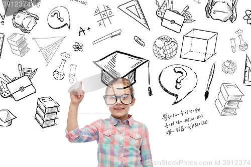 Image of happy little girl in eyeglasses pointing finger up