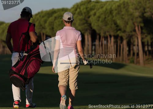 Image of couple walking on golf course