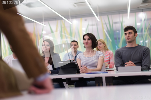 Image of teacher with a group of students in classroom