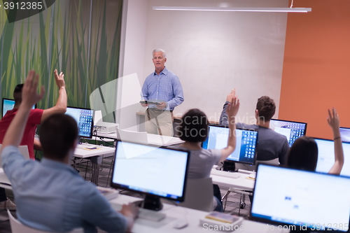 Image of teacher and students in computer lab classroom