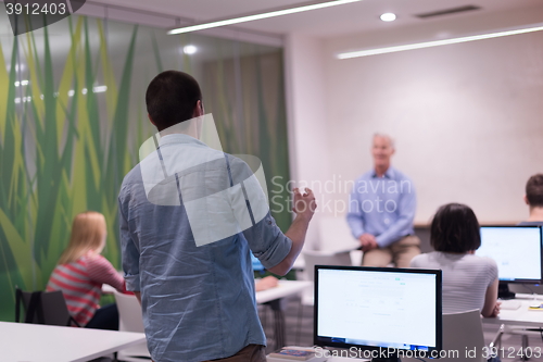 Image of student answering a question in classroom