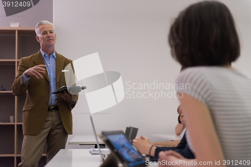 Image of teacher with a group of students in classroom