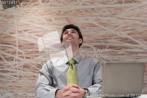 Image of young business man  working on laptop  computer at modern office