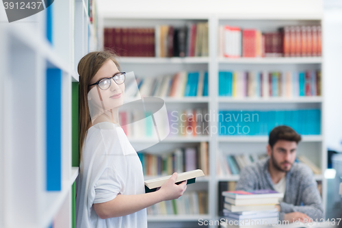 Image of students couple  in school  library